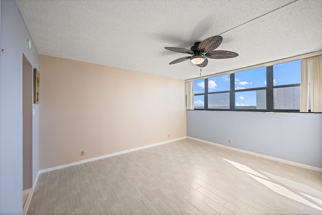 336 Golfview Rd Unit 916, North Palm Beach, FL 33408 - unfurnished room with light wood-type flooring, baseboards, a ceiling fan, and a textured ceiling