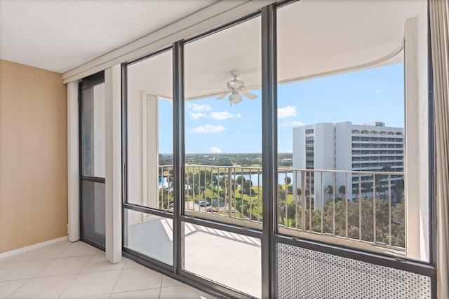 336 Golfview Rd Unit 916, North Palm Beach, FL 33408 - entryway with a textured ceiling, floor to ceiling windows, a ceiling fan, tile patterned flooring, and a water view
