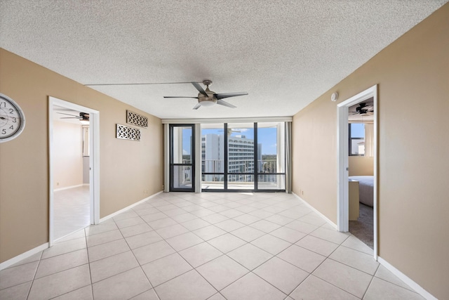 336 Golfview Rd Unit 916, North Palm Beach, FL 33408 - unfurnished room featuring a city view, light tile patterned flooring, a ceiling fan, and expansive windows