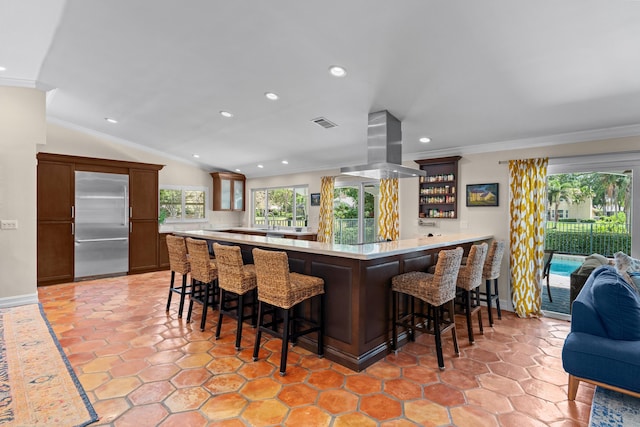 bar featuring ornamental molding, stainless steel built in refrigerator, recessed lighting, and island exhaust hood