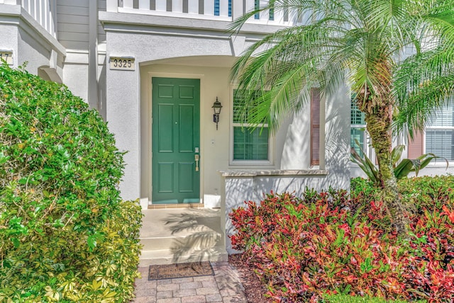 doorway to property with stucco siding