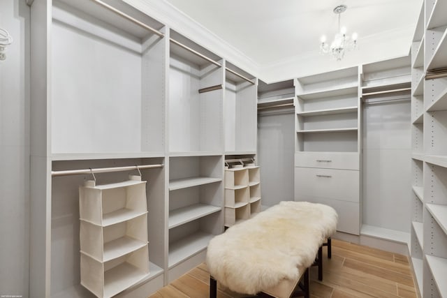 13268 Polo Club Rd Unit A104, Wellington, FL 33414 - spacious closet featuring a notable chandelier and wood tiled floor