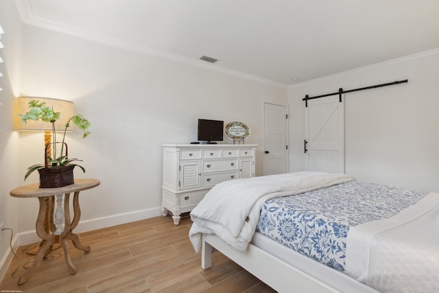 13268 Polo Club Rd Unit A104, Wellington, FL 33414 - bedroom featuring light wood-style flooring, crown molding, baseboards, and a barn door