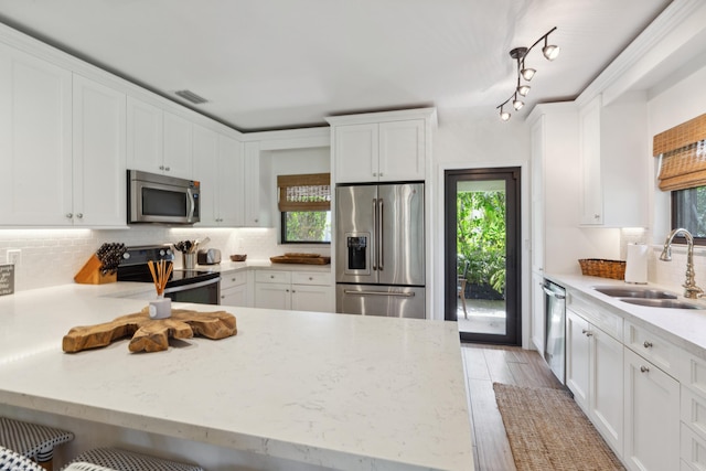 13268 Polo Club Rd Unit A104, Wellington, FL 33414 - kitchen with visible vents, white cabinetry, a sink, and appliances with stainless steel finishes