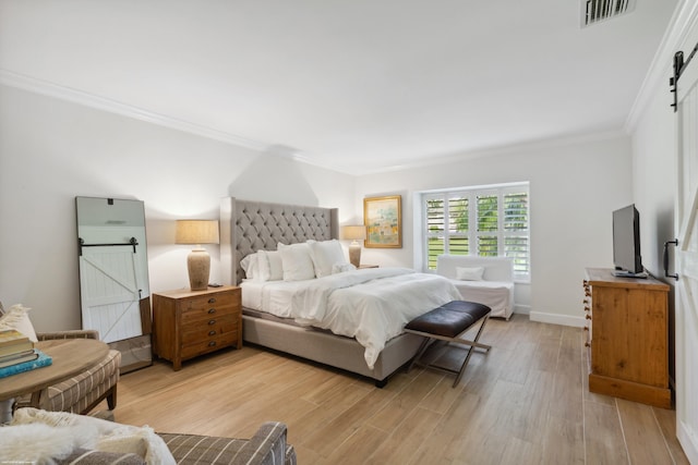 13268 Polo Club Rd Unit A104, Wellington, FL 33414 - bedroom featuring a barn door, visible vents, light wood-type flooring, and ornamental molding