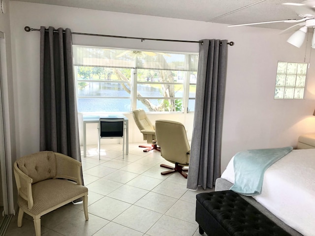 bedroom with light tile patterned floors and multiple windows