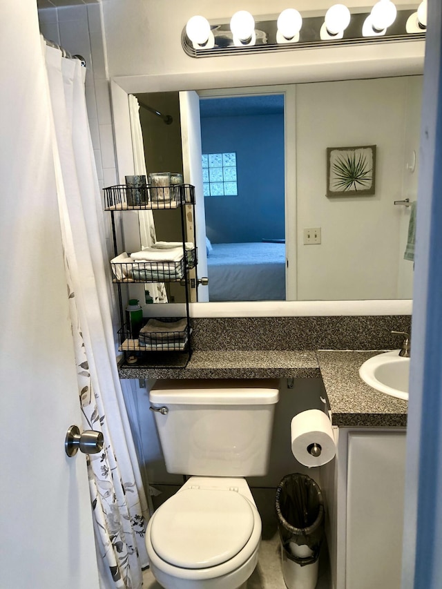 ensuite bathroom featuring vanity, toilet, and ensuite bathroom