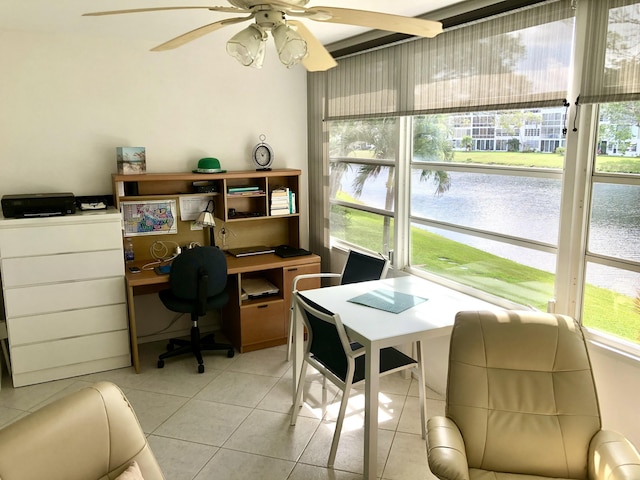 sunroom featuring a water view