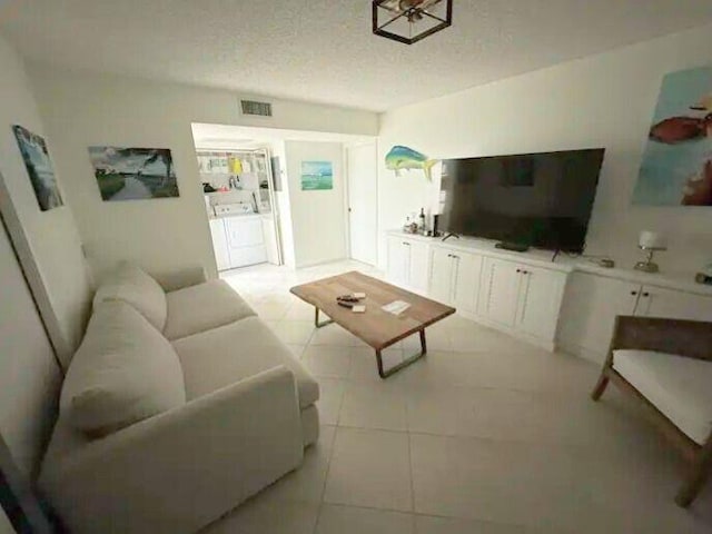 600 Executive Center Dr Unit 106, West Palm Beach, FL 33401 - living room featuring a textured ceiling, light tile patterned floors, and visible vents