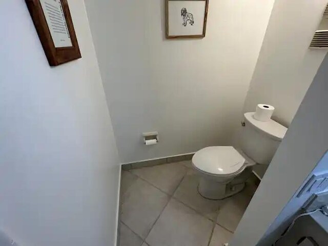 600 Executive Center Dr Unit 106, West Palm Beach, FL 33401 - bathroom featuring toilet, tile patterned flooring, and baseboards