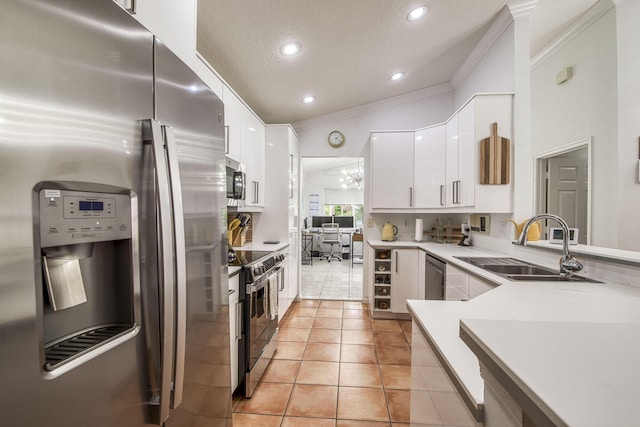 104 Cove Rd, Greenacres, FL 33413 - kitchen with appliances with stainless steel finishes, crown molding, a sink, white cabinets, and light tile patterned floors