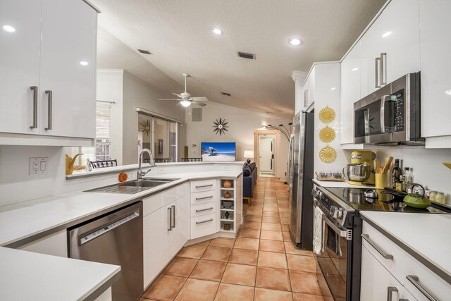 kitchen with visible vents, open floor plan, white cabinetry, and ornamental molding