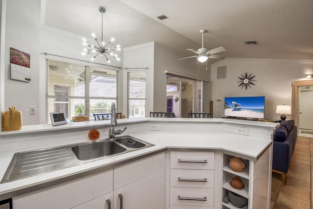 104 Cove Rd, Greenacres, FL 33413 - kitchen featuring open floor plan, ornamental molding, white cabinets, light countertops, and vaulted ceiling