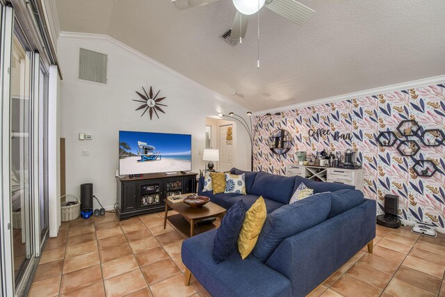 living area with crown molding, a textured ceiling, light tile patterned floors, lofted ceiling, and visible vents