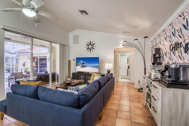 living area with crown molding, a textured ceiling, light tile patterned floors, and ceiling fan with notable chandelier
