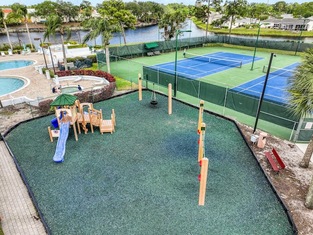 104 Cove Rd, Greenacres, FL 33413 - view of tennis court with fence, a community pool, and a water view