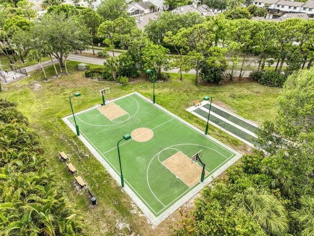 view of tennis court featuring a water view and fence
