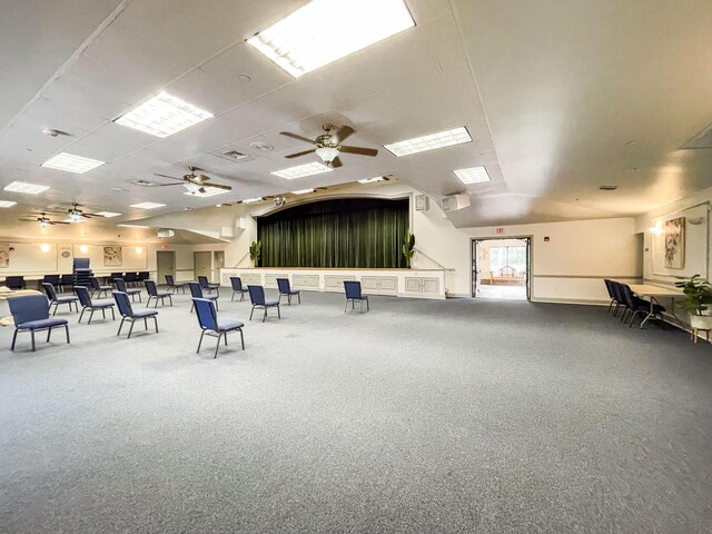 gym with ceiling fan and a drop ceiling