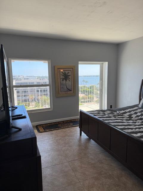 bedroom with baseboards and multiple windows
