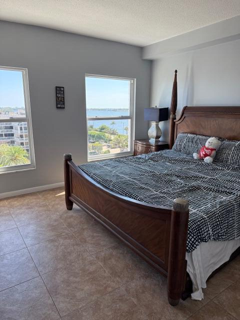 bedroom with tile patterned flooring and baseboards