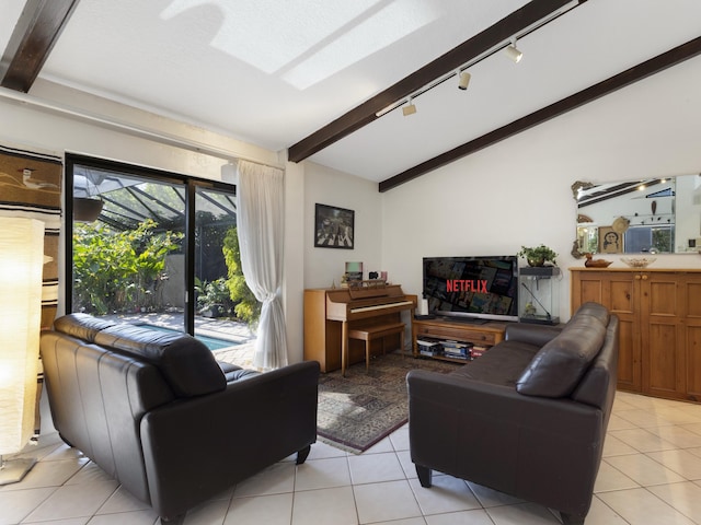 living room featuring rail lighting, light tile patterned flooring, and lofted ceiling with beams