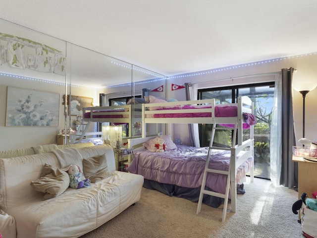 carpeted bedroom with access to outside