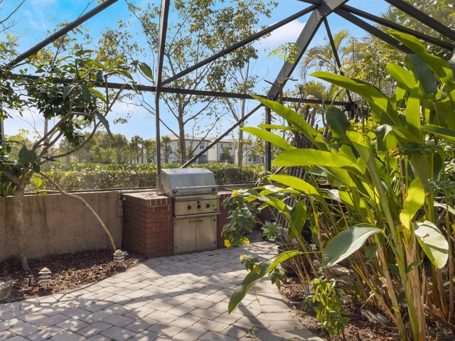 view of patio / terrace featuring an outdoor kitchen, fence, and a grill