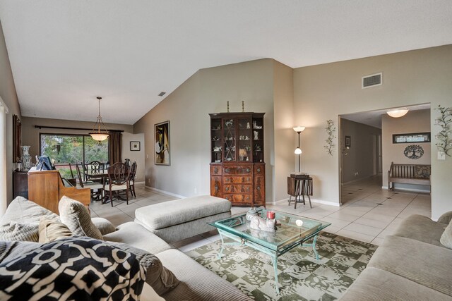8933 NW 3rd Ct, Coral Springs, FL 33071 - living area with high vaulted ceiling, light tile patterned floors, visible vents, and baseboards