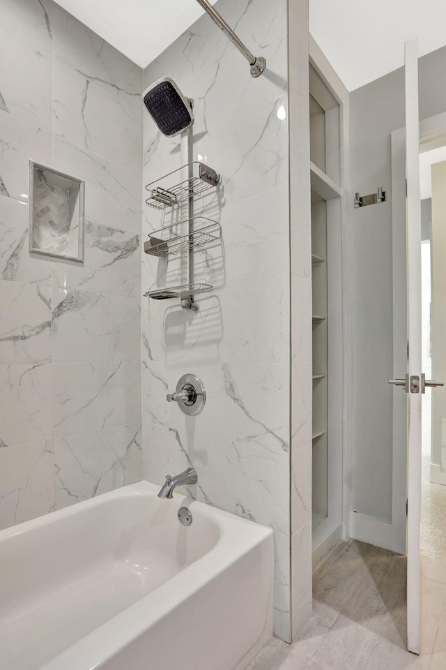 bathroom with  shower combination and marble look tile flooring