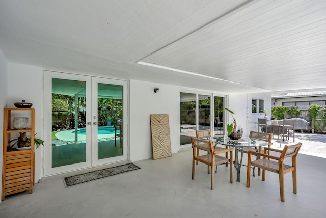 sunroom / solarium featuring french doors and healthy amount of natural light