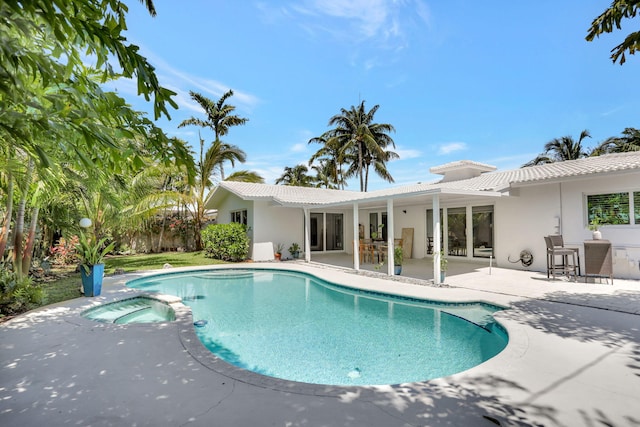 view of pool with a patio area and a pool with connected hot tub