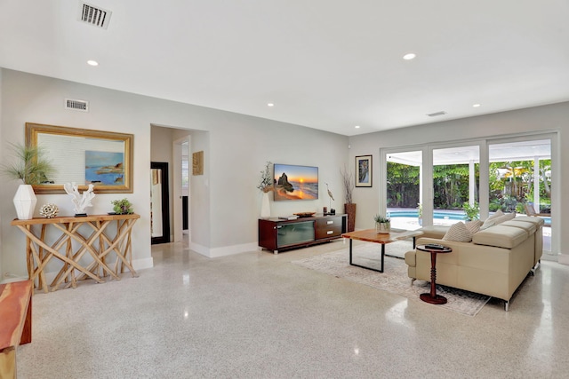 living area with speckled floor, baseboards, and recessed lighting