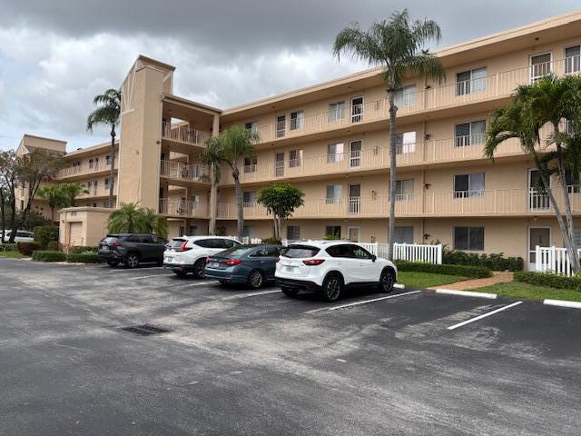 view of building exterior with uncovered parking