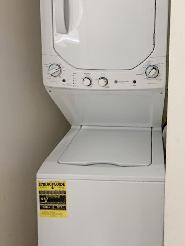 6935 Huntington Ln Unit 205, Delray Beach, FL 33446 - washroom with stacked washer / drying machine