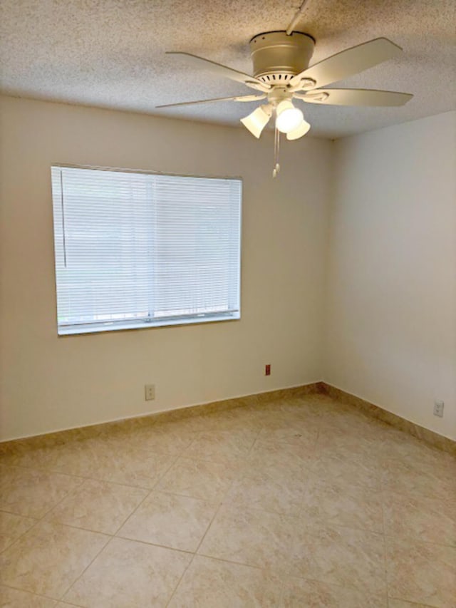 6935 Huntington Ln Unit 205, Delray Beach, FL 33446 - unfurnished room with plenty of natural light, a ceiling fan, a textured ceiling, and light tile patterned flooring