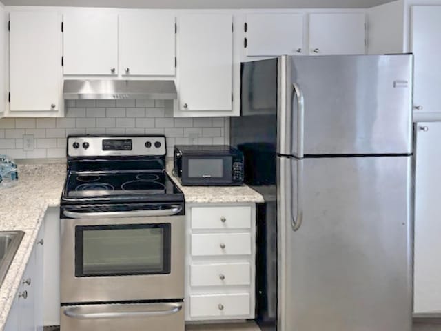 6935 Huntington Ln Unit 205, Delray Beach, FL 33446 - kitchen featuring appliances with stainless steel finishes, ventilation hood, white cabinets, and tasteful backsplash