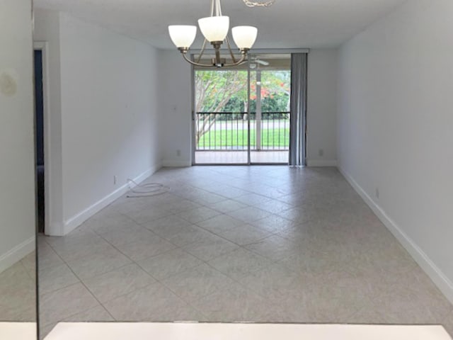 6935 Huntington Ln Unit 205, Delray Beach, FL 33446 - tiled empty room featuring a chandelier and baseboards