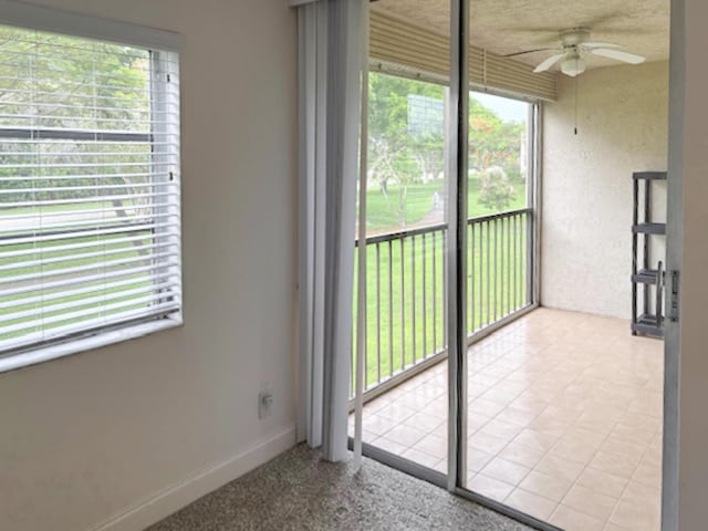 6935 Huntington Ln Unit 205, Delray Beach, FL 33446 - unfurnished sunroom with ceiling fan and plenty of natural light