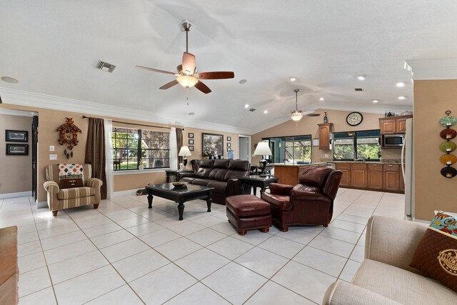 6045 Whipoorwill Ln, Fort Pierce, FL 34987 - living room featuring vaulted ceiling, ceiling fan, light tile patterned flooring, crown molding, and baseboards