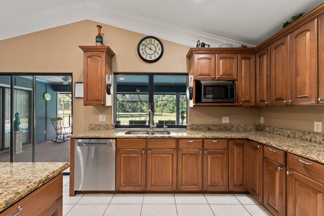 6045 Whipoorwill Ln, Fort Pierce, FL 34987 - kitchen with appliances with stainless steel finishes, a sink, lofted ceiling, light stone countertops, and brown cabinetry