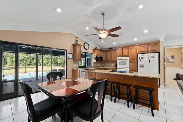 6045 Whipoorwill Ln, Fort Pierce, FL 34987 - dining area featuring crown molding, a ceiling fan, vaulted ceiling, recessed lighting, and light tile patterned floors