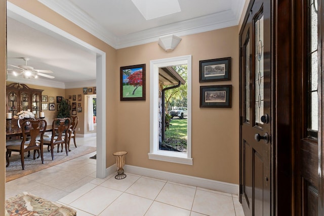 6045 Whipoorwill Ln, Fort Pierce, FL 34987 - foyer entrance with crown molding, light tile patterned flooring, baseboards, and a skylight