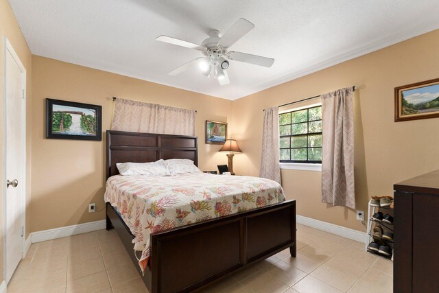 6045 Whipoorwill Ln, Fort Pierce, FL 34987 - bedroom with light tile patterned floors, baseboards, and a ceiling fan