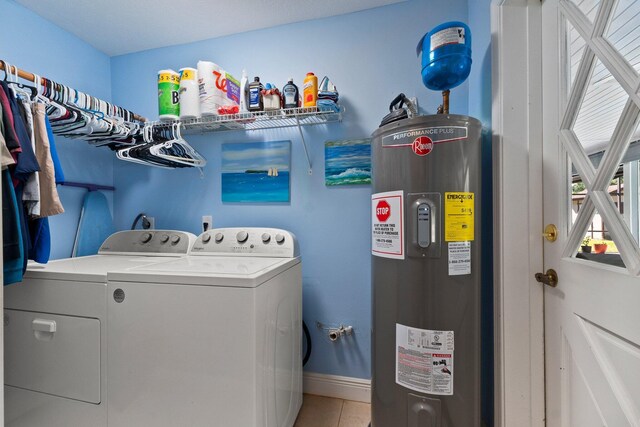 6045 Whipoorwill Ln, Fort Pierce, FL 34987 - laundry area with electric water heater, washing machine and dryer, tile patterned flooring, and baseboards