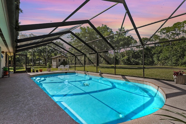 6045 Whipoorwill Ln, Fort Pierce, FL 34987 - outdoor pool with a patio area, glass enclosure, and a yard
