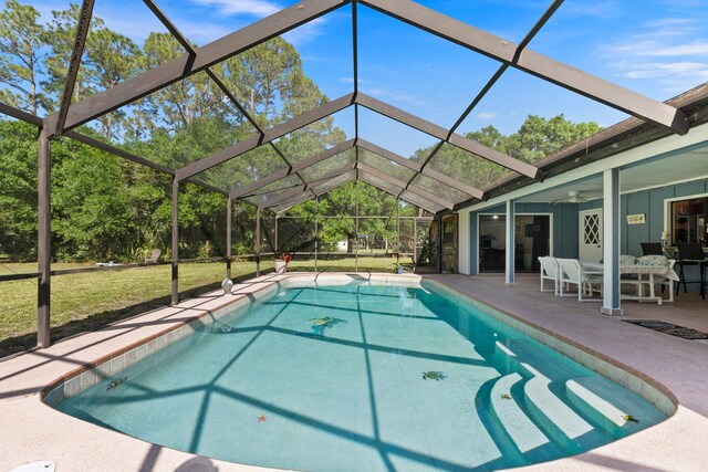 6045 Whipoorwill Ln, Fort Pierce, FL 34987 - outdoor pool featuring a patio, glass enclosure, a ceiling fan, and a lawn