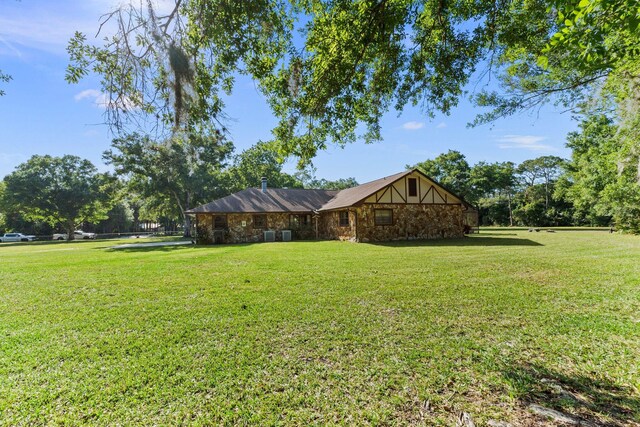 6045 Whipoorwill Ln, Fort Pierce, FL 34987 - view of front of home with a front yard and stone siding