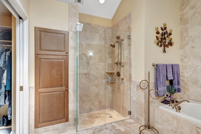 1485 Bear Island Dr, West Palm Beach, FL 33409 - bathroom with a bath, visible vents, a spacious closet, and a shower stall