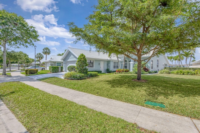 1485 Bear Island Dr, West Palm Beach, FL 33409 - view of front of home featuring stucco siding, a front yard, a tile roof, an attached garage, and concrete driveway