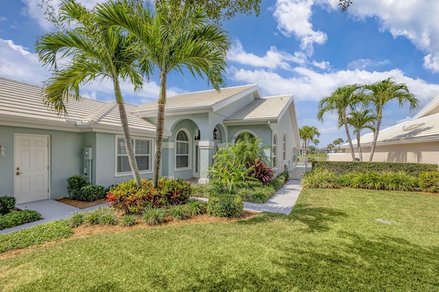 1485 Bear Island Dr, West Palm Beach, FL 33409 - exterior space featuring stucco siding, a gate, a front lawn, and a tile roof